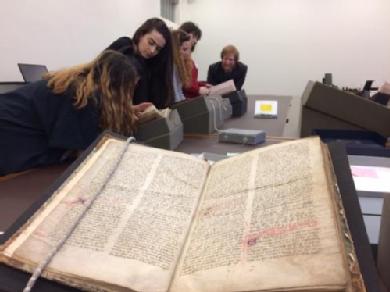 Students looking at manuscripts