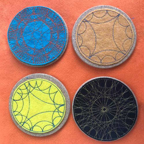 Four embroidered sunquakes, showing repeating patterns on a circle