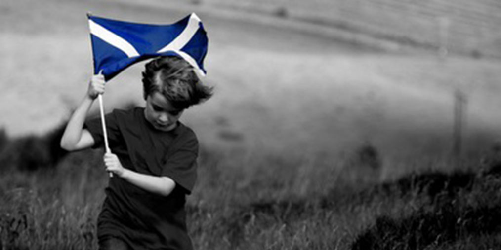 Boy running with Scotland flag